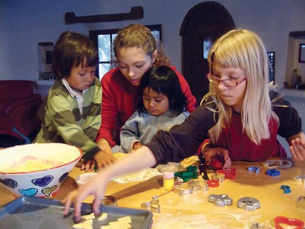 Treska and her sister, Kaya, help neighbors Rafa and Tono make sugar cookies with eggs from their chickens.